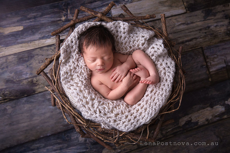  baby boy with the cute long hair sleeping in the prop nest