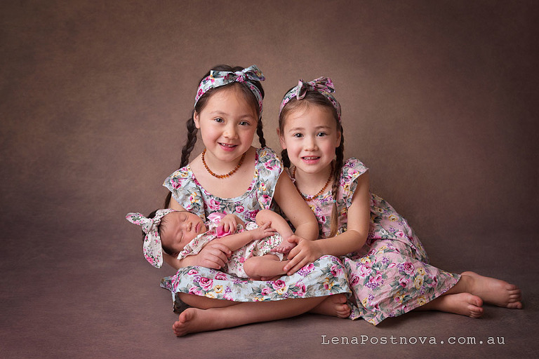 newborn baby girl with two older siblings