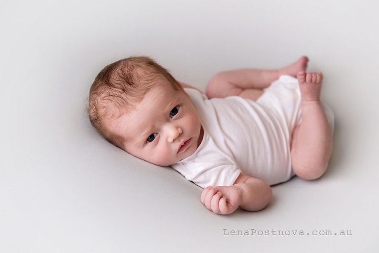 Newborn Photo -  awake portrait of Neworn baby wearing white onesie