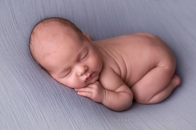 cute newborn on the blue backdrop