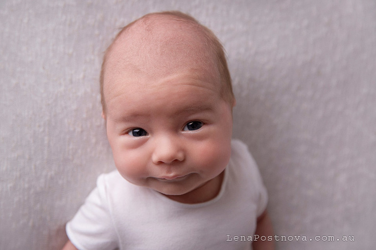 one months old baby looking ate the camera - Newborn photography of older baby
