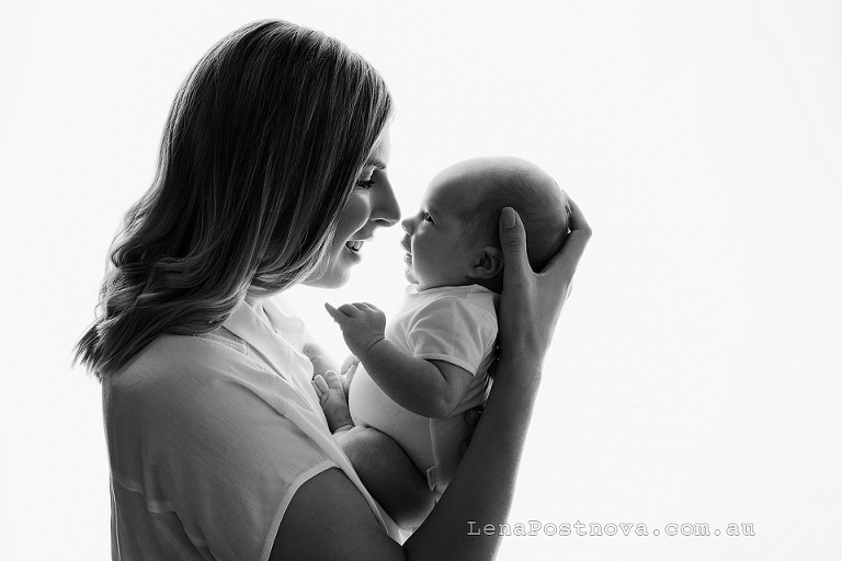 Newborn photography older baby - mum holding baby backlit