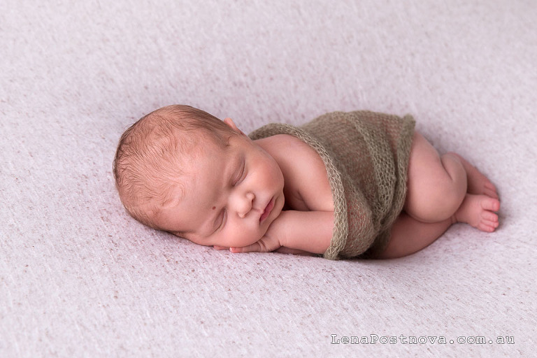 newborn baby posed on the side