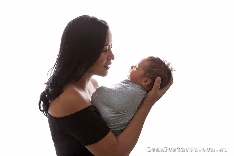 Newborn Baby Photography Sydney - gorgeous mum smiling at her newborn