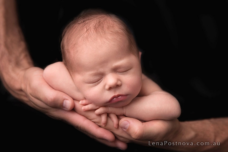 newborn baby in father's hands
