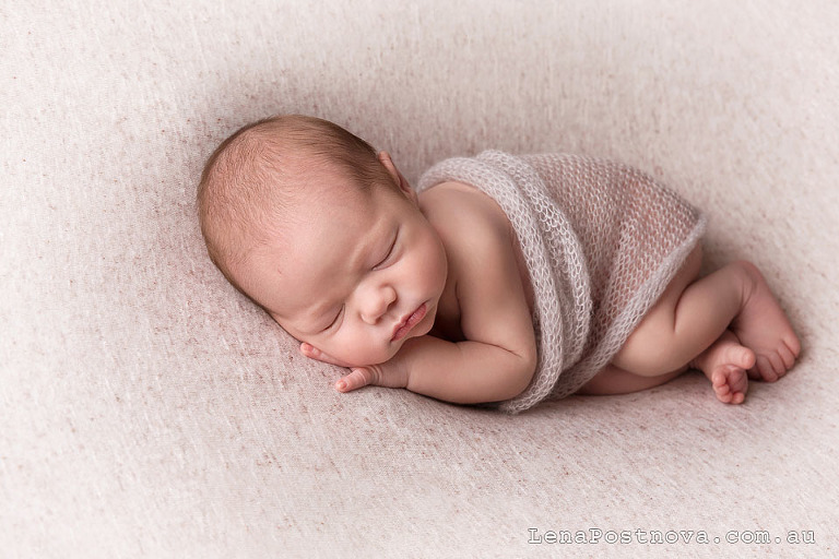 Newborn baby sleeping on the side