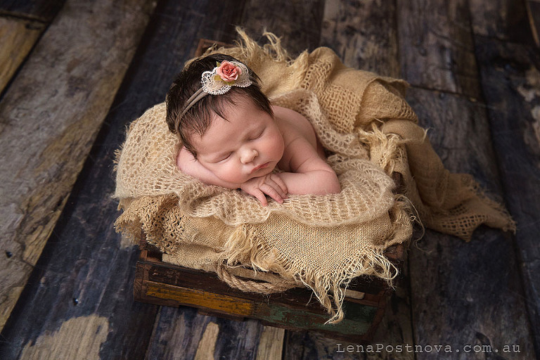 Newborn Photoshoot of a long haired baby in the vintage box prop