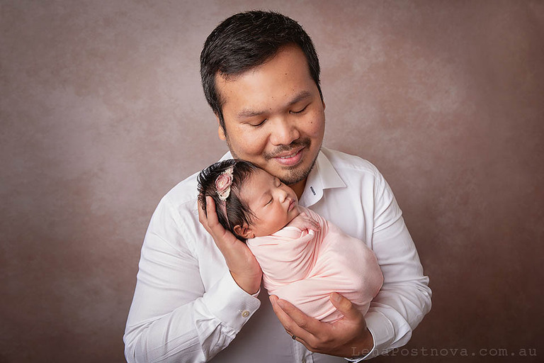 newborn photography portrait of a father with newborn baby girl