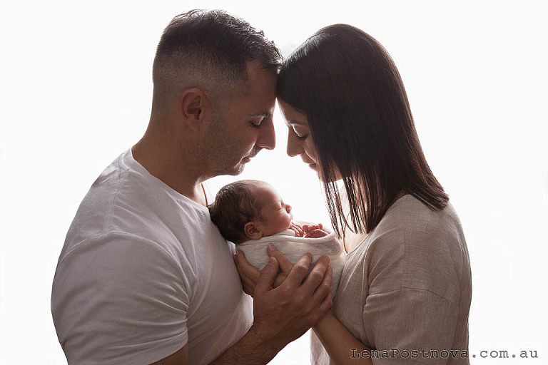 mother and father with the baby captured during in-home Newborn family photoshoot in Sydney 