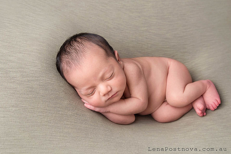 newborn baby posed nicely on the side 