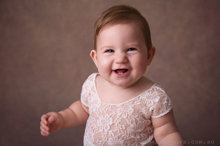 sitter session baby girl 8 months old smiling