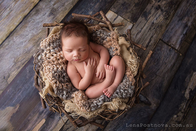 Newborn Photography Poses - baby on the back in the prop