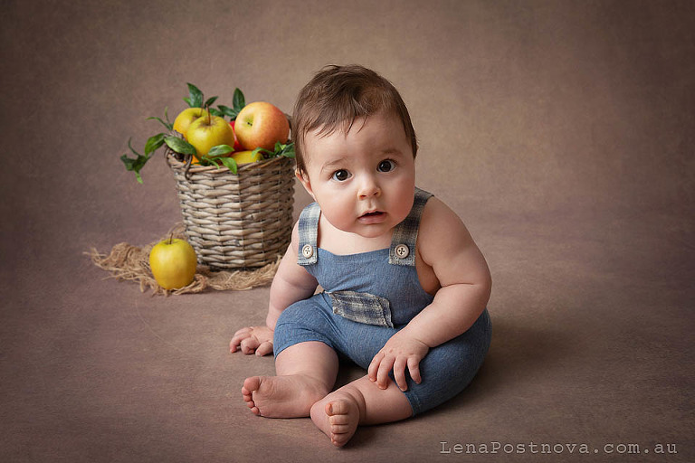 little boy sitting with the fruit basket