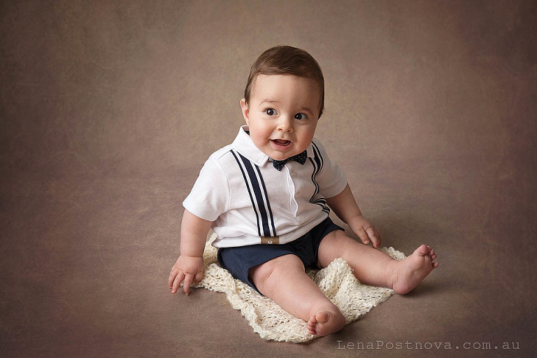 little boy sitting and smiling 