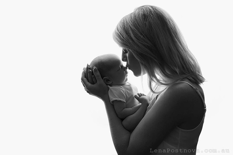 mother kissing her baby 