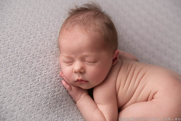 new born baby posed on the bean bag