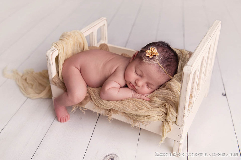  baby girl on the doll bed 