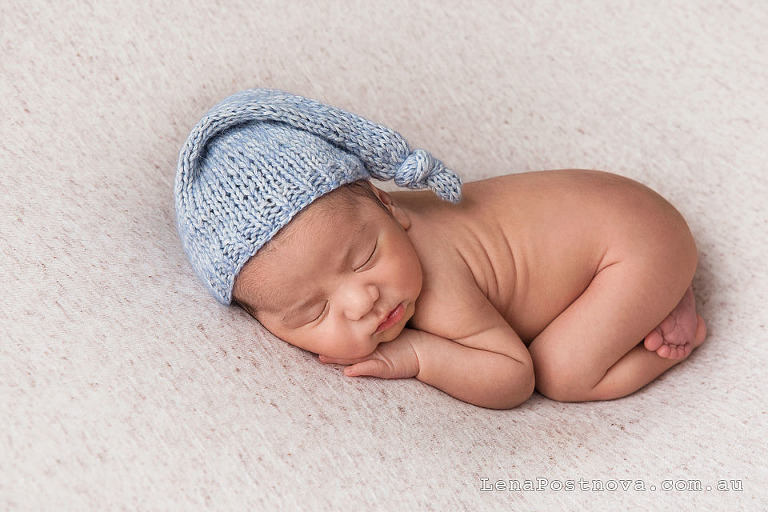 newborn baby sleeping, wearing adorable sleepy hat