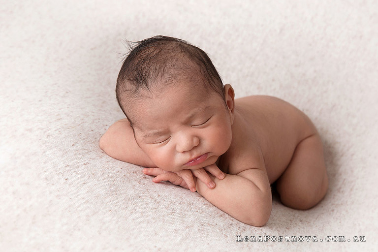 newborn baby boy posed on his tummy