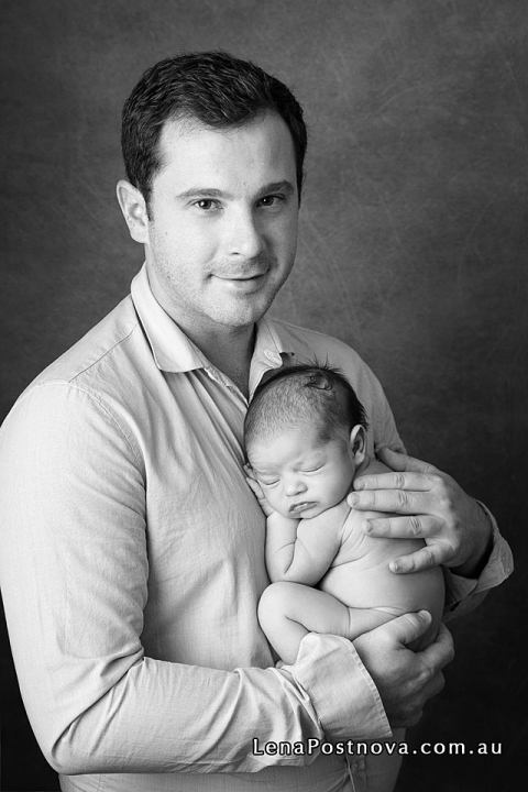 father holding newborn son 