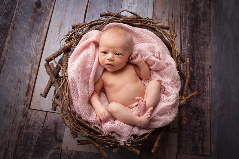 newborn baby in the prop at her in home newborn photography session