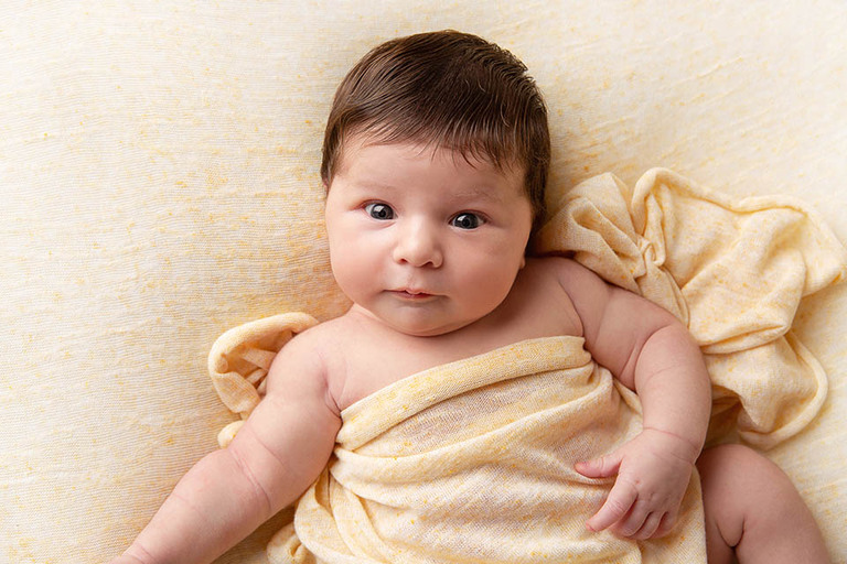 cute long-haired awake newborn baby 