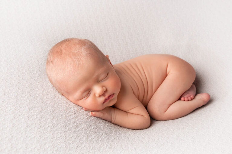 sleepy newborn at her newborn photo shoot 