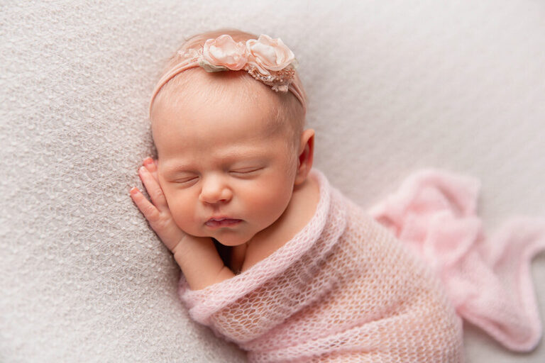 posed sleepy newborn baby at her in home newborn photography session