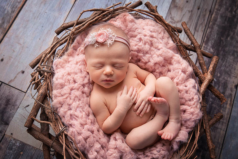 posed sleepy newborn baby at her in home newborn photo shoot Sydney