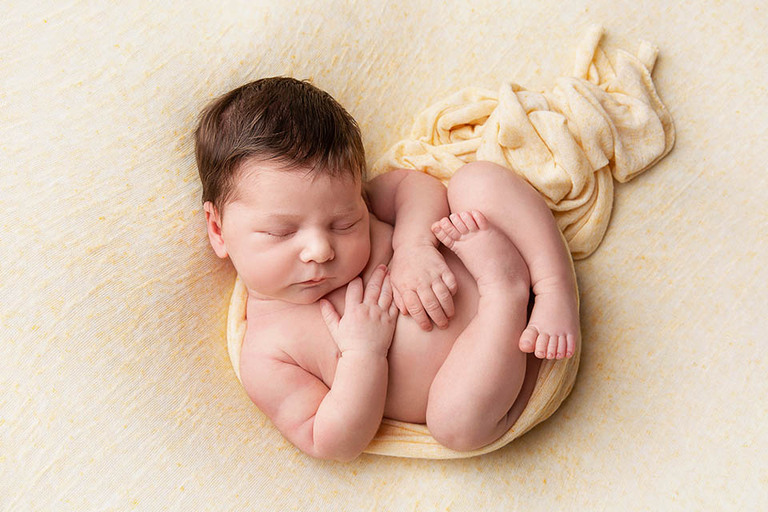 newborn baby curled up