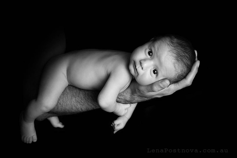 Baby in Dad's loving arms.